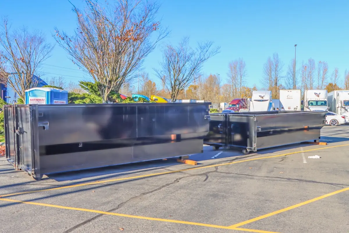 Professional dumpster rental service with roll-off container on residential driveway in Berlin